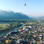 Drone Shot of a Hot Air Balloon Above a City